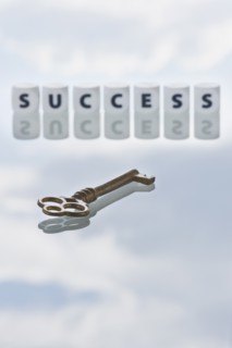 Studio shot of key and dice spelling out success. Photo : Daniel Grill