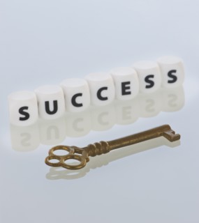 Studio shot of key and dice spelling out success. Photo : Daniel Grill