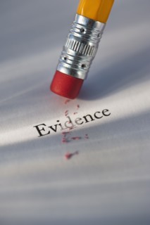 Studio shot of pencil erasing the word evidence from piece of paper. Photo : Daniel Grill