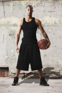 USA, Utah, Salt Lake City, Portrait of young man with basketball against dilapidated wall. Photo :