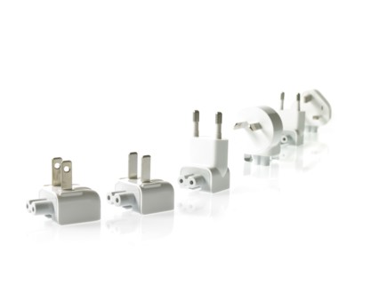 Row of plugs on white background. Photo : David Arky
