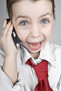 Studio portrait of girl (6-7) dressed-up as businesswoman. Photo : Justin Paget