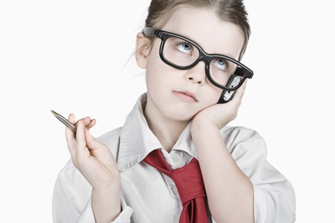 Studio portrait of girl (6-7) dressed-up as businesswoman. Photo : Justin Paget