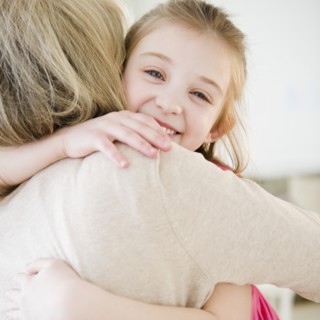Mother and daughter (10-11) hugging. Photo : Jamie Grill Photography