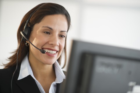 Smiling female customer service representative with headset.