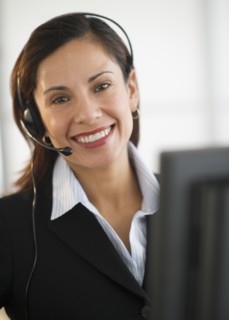 Smiling female customer service representative with headset.