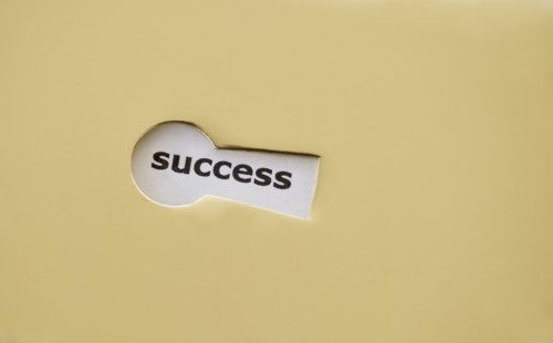 Studio shot of keyhole showing the word success. Photo : Daniel Grill