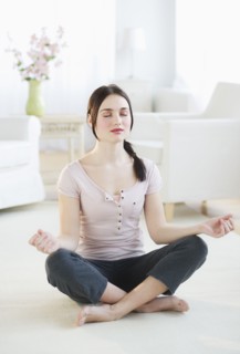 Woman practicing yoga at home. Photo : Daniel Grill