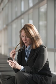 Businesswoman text-messaging. Photo: Mark Edward Atkinson