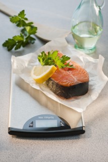Slice of salmon on weight scale.