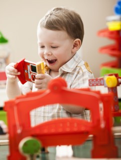 Boy (2-3) playing with colorful toys. Photo : Mike Kemp