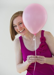 Woman holding balloon.