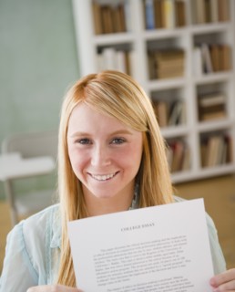 Female student showing essay. Photo : Jamie Grill Photography