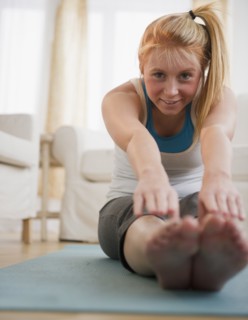 Woman stretching. Photo : Jamie Grill Photography