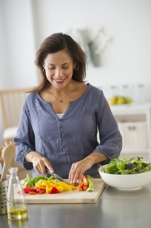 Woman preparing food in kitchen.