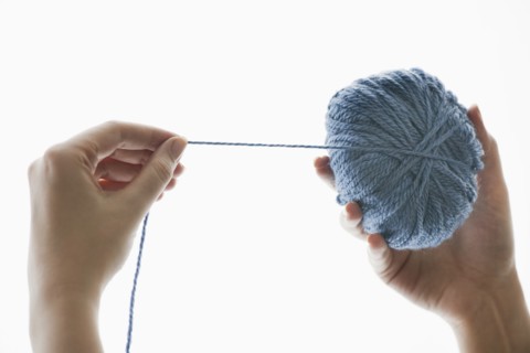 Studio shot of woman with ball of wool.