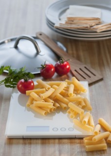 Raw pasta on weight scale.