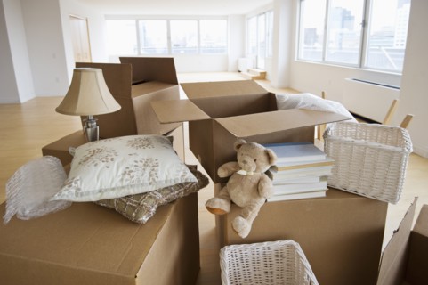 Boxes and decors stacked in room.