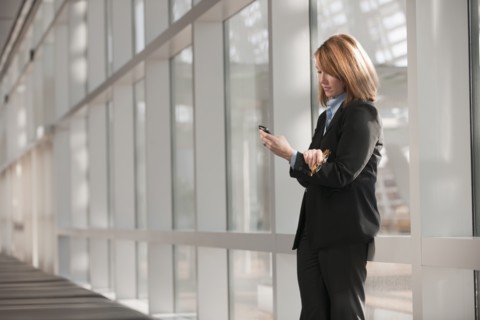 Businesswoman text-messaging. Photo: Mark Edward Atkinson