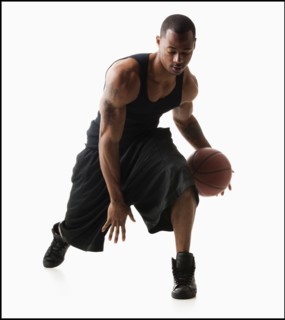 Studio shot of man playing basketball. Photo : Mike Kemp