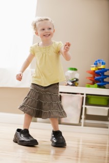 Girl (2-3) walking in dad's shoes. Photo: Mike Kemp