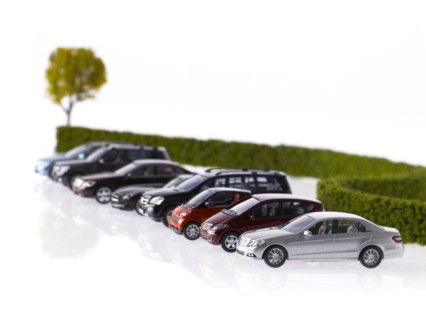 Row of different cars parked near hedge. Photo: David Arky