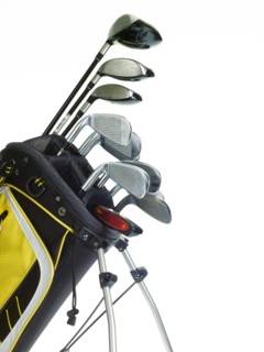 Golf bag with clubs on white background. Photo : David Arky