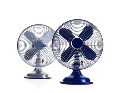 Two electric fans on white background. Photo : David Arky