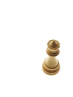 White queen chess piece on white background. Photo : David Arky
