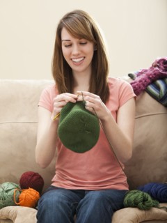 Young woman knitting woolly hat. Photo: Mike Kemp