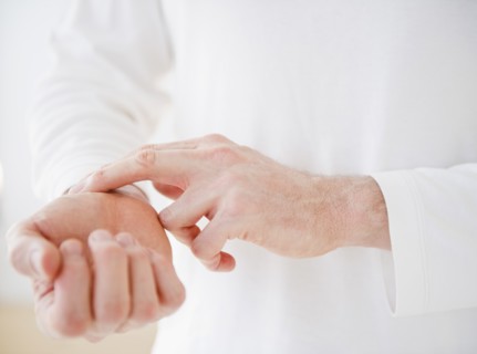 Hands taking pulse. Photo : Jamie Grill Photography