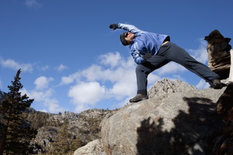 USA, California, Lake Tahoe, Woman exercising on rock. Photo : Noah Clayton