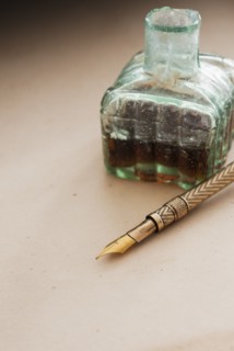 Close up antique ink well and pen.