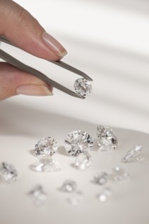 Studio shot of woman holding diamonds.