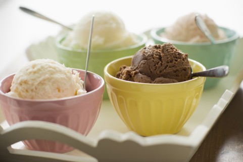 Close up of bowls with ice cream selection on tray.