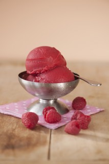 Close up of ice cream and raspberries.