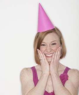 Portrait of woman wearing pink party hat.