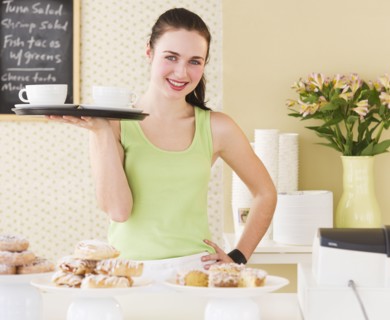 Portrait of waitress holding tray. Photo : Daniel Grill