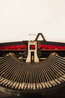Close up of antique typewriter with "the end" print on page.