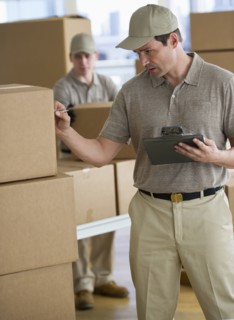 Man checking checklist in warehouse.