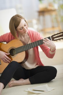 Woman playing guitar.