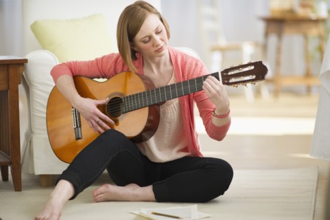 Woman playing guitar.