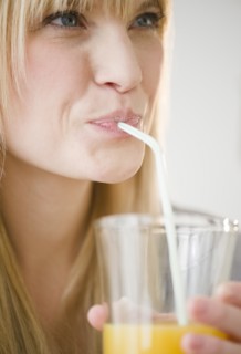 Young woman drinking juice. Photo : Jamie Grill Photography