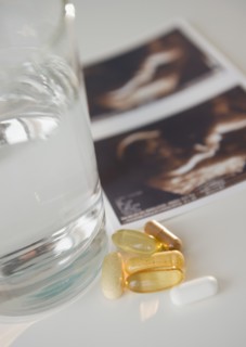 Sonogram picture, pills and glass of water. Photo: Jamie Grill Photography