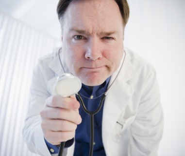 Doctor holding stethoscope. Photo : Jamie Grill Photography