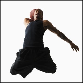 Studio shot of young man playing basketball. Photo : Mike Kemp