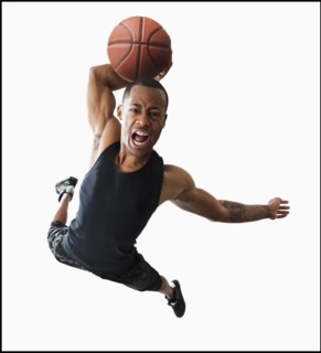 Studio shot of young man playing basketball. Photo : Mike Kemp