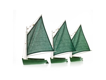 Row of toy boats on white background. Photo: David Arky