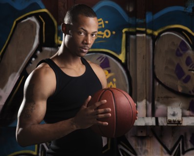 Portrait of young man with basketball. Photo : Mike Kemp