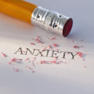 Studio shot of pencil erasing the word anxiety from piece of paper. Photo : Daniel Grill